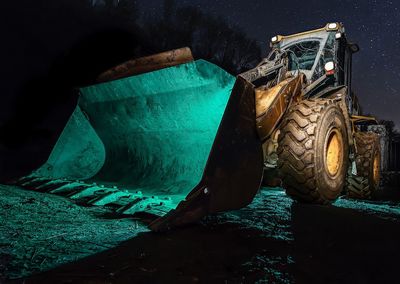 Close-up of bulldozer at night