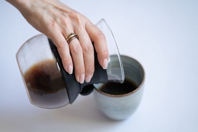 Midsection of woman holding coffee cup