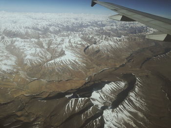 Aerial view of airplane wing over landscape