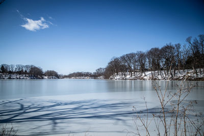 Scenic view of lake against sky during winter