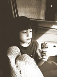 High angle view of girl looking down while sitting