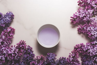 Purple flowers and cup with purple liquid