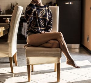 Woman sitting on chair at home