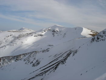 Scenic view of snowcapped mountains against sky