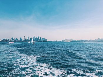 View of city at waterfront against sky