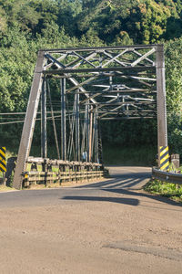 Bridge over road against trees