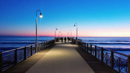 Pier on sea against clear sky