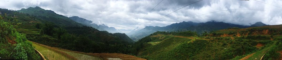 Scenic view of mountains against cloudy sky