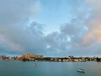 Panoramic view of sea and buildings against sky