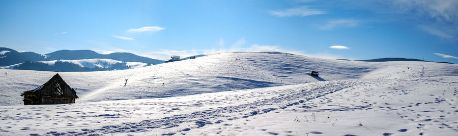 Scenic view of snow covered mountains against sky