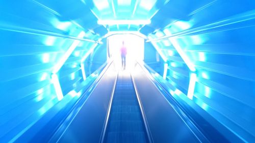 Low angle view of illuminated escalator in subway