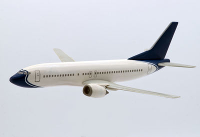 Low angle view of airplane flying against clear sky
