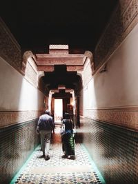 Rear view of people walking in corridor