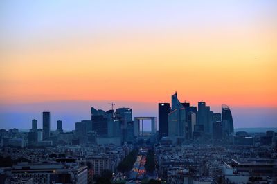 Buildings in city at sunset