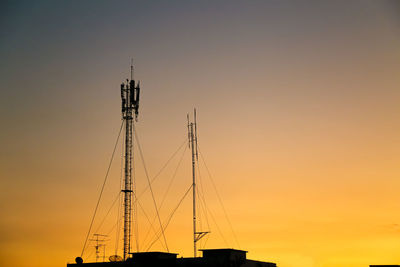 Transmission tower technology communication light sunset city background