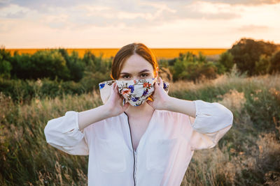 Statement masks, blinged out diy flower face mask design. girl in face mask decorated with flowers 