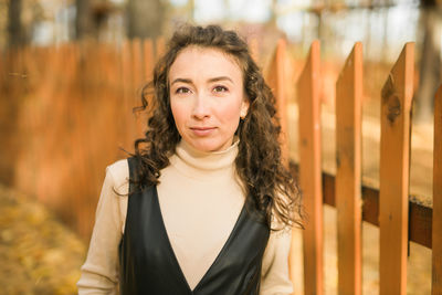 Portrait of young woman standing outdoors