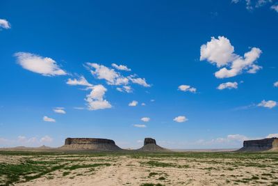 Scenic view of land against blue sky