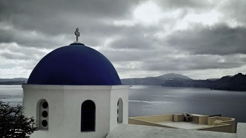 Church by building against sky
