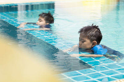 Portrait of boy swimming in pool