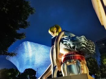 Low angle view of statue against sky at night