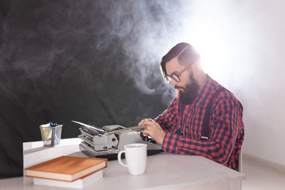 Young man sitting on table