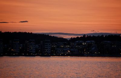 Scenic view of sea against orange sky