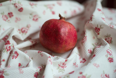 Close-up of pomegranate on textile