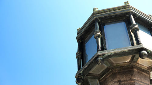 Low angle view of old building against clear blue sky