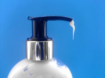 Close-up of water bottle against blue background