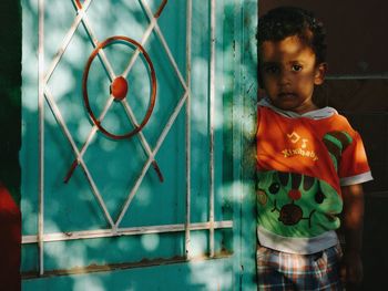 Portrait of boy standing on floor