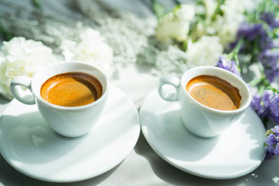 Close-up of cup and coffee on table