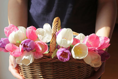 Close-up of pink flowers in basket on table