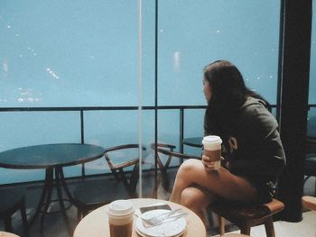 Woman sitting on chair in cafe