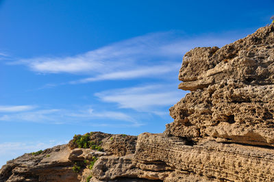 Low angle view of rock formations against sky