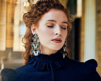 Close-up portrait of young woman with eyes closed