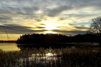 Scenic view of lake against sky during sunset