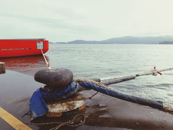 Boat moored in sea against sky