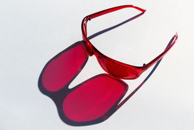 Close-up of sunglasses on table against white background