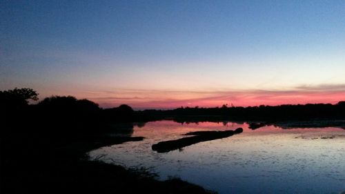 Scenic view of lake at sunset