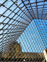 Low angle view of metallic ceiling against sky