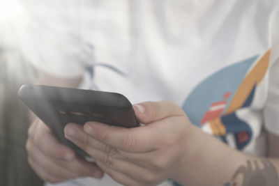 Midsection of man using mobile phone