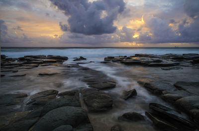 Scenic view of sea against dramatic sky