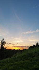 Scenic view of field against sky during sunset