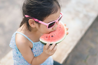 High angle view of girl eating watermelon