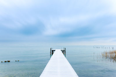 Pier over sea against sky