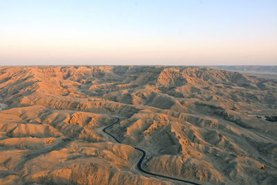 Aerial view of desert against clear sky