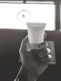 Close-up of hand holding tea cup