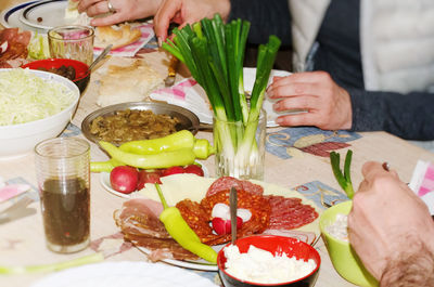Midsection of woman preparing food at restaurant table