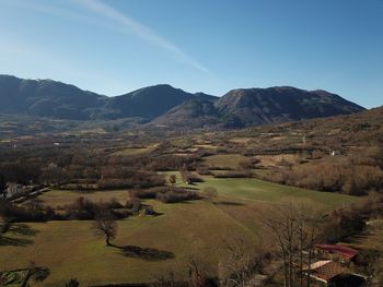 Scenic view of mountains against clear blue sky